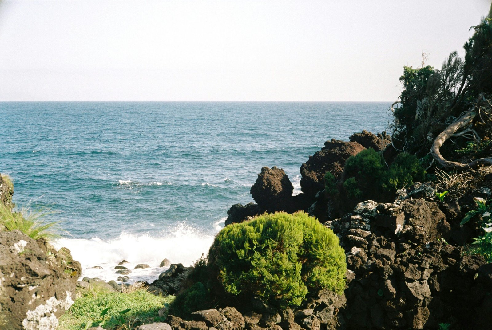 a view of the ocean from a rocky cliff